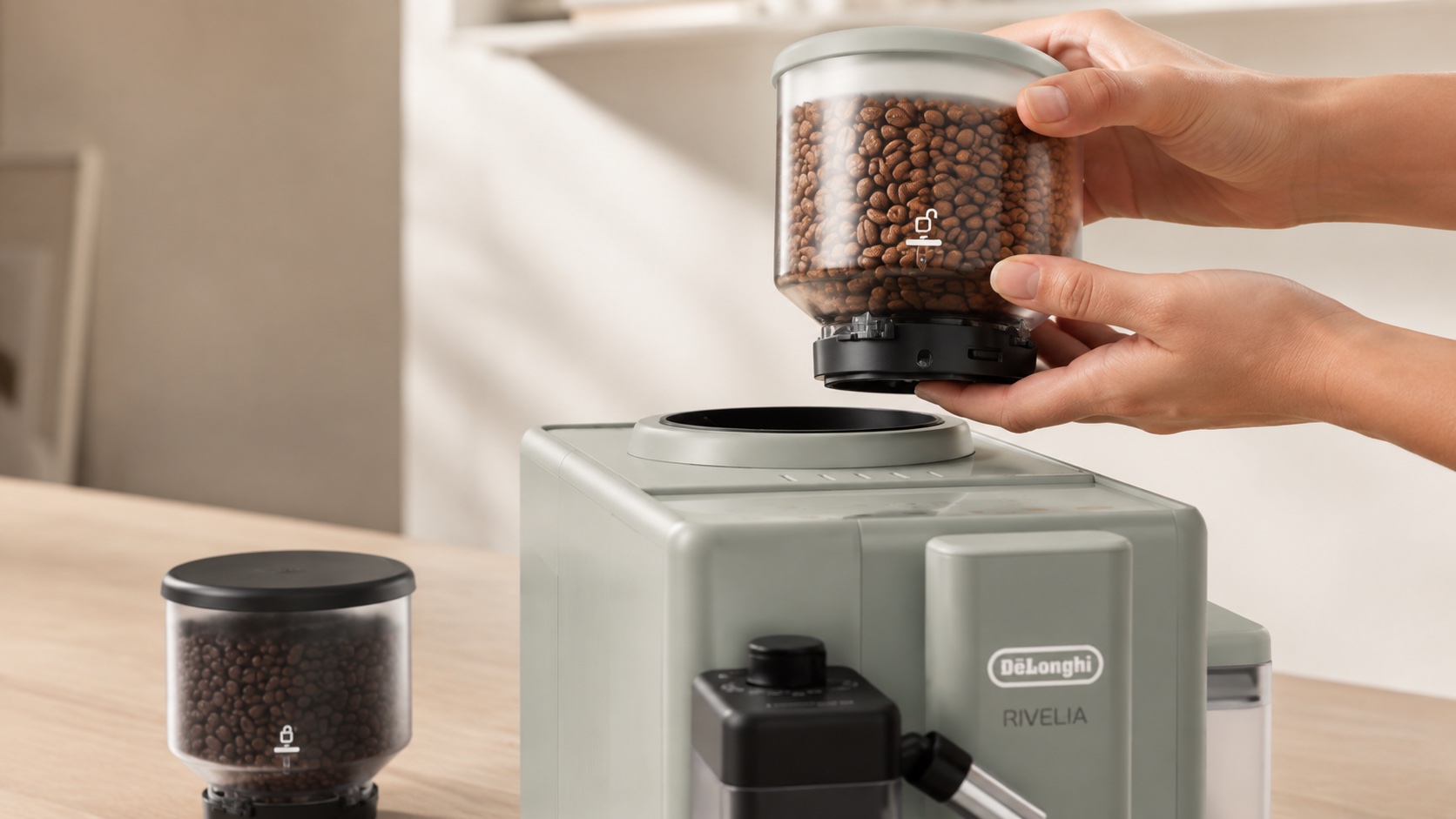 Hand lifting a sealed coffee bean hopper away from an automatic coffee machine